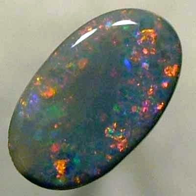 SOLID BLACK OPAL Large central rolling flash of bright crimson surrounded by sparkles of the same colour.