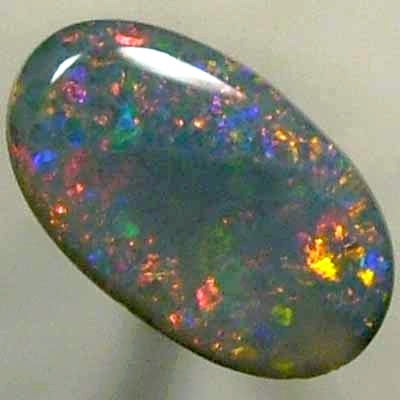 SOLID BLACK OPAL Large central rolling flash of bright crimson surrounded by sparkles of the same colour.