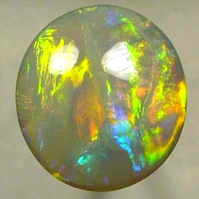 SOLID SEMI BLACK OPAL Very bright neon golds shades moving in large rolling flashes over peacock colours