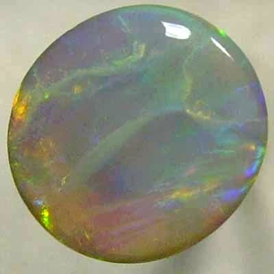 SOLID SEMI BLACK OPAL Very bright neon golds shades moving in large rolling flashes over peacock colours