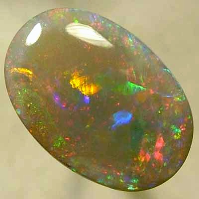SOLID SEMI BLACK OPAL Large rolling flashes of reds with green and blue. With VIDEO