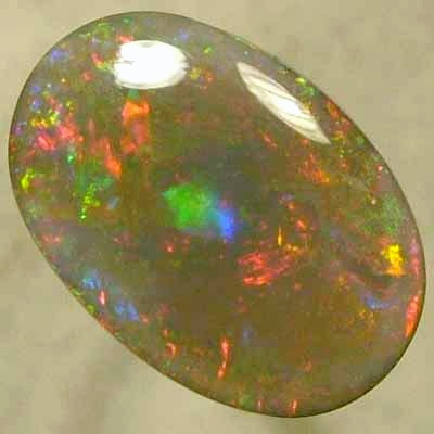 SOLID SEMI BLACK OPAL Large rolling flashes of reds with green and blue. With VIDEO