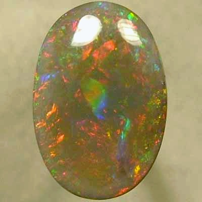 SOLID SEMI BLACK OPAL Large rolling flashes of reds with green and blue. With VIDEO