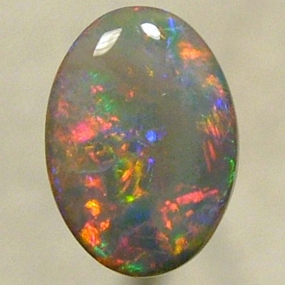 SOLID SEMI BLACK OPAL Rolling flashes of bright red with greens chasing the reds. 
