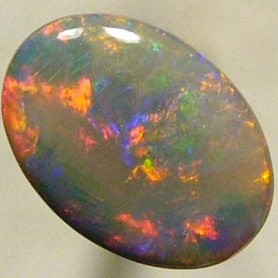 SOLID SEMI BLACK OPAL Rolling flashes of bright red with greens chasing the reds. 