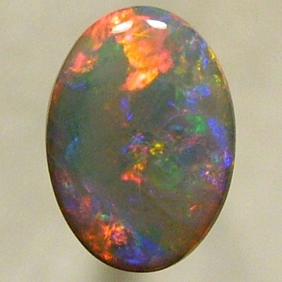 SOLID SEMI BLACK OPAL Rolling flashes of bright red with greens chasing the reds. 