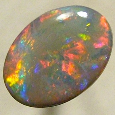 SOLID SEMI BLACK OPAL Rolling flashes of bright red with greens chasing the reds. 