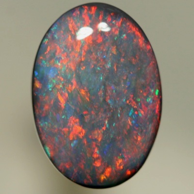 SOLID BLACK OPAL Red and orange sparkles over a touch of green and blue. SEE VIDEO