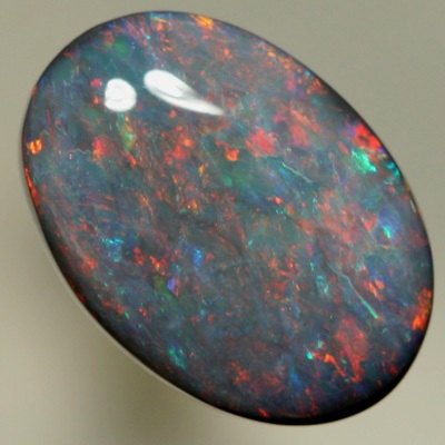 SOLID BLACK OPAL Red and orange sparkles over a touch of green and blue. SEE VIDEO