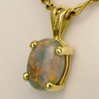 18k Yellow Gold Pendant with a SEMI BLACK SOLID OPAL Bright red and orange plays over green and purple