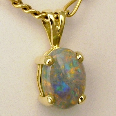 18k Yellow Gold Pendant with a SEMI BLACK SOLID OPAL Bright red and orange plays over green and purple